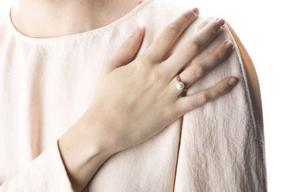 Yellow and white gold ring adorned with an...