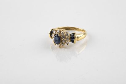 Yellow gold daisy ring holding an oval cut...