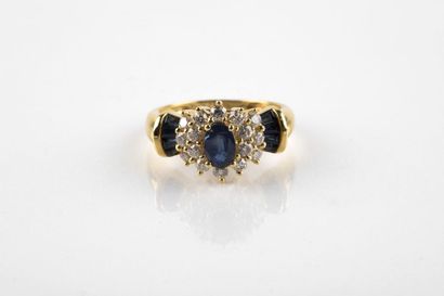 Yellow gold daisy ring holding an oval cut...