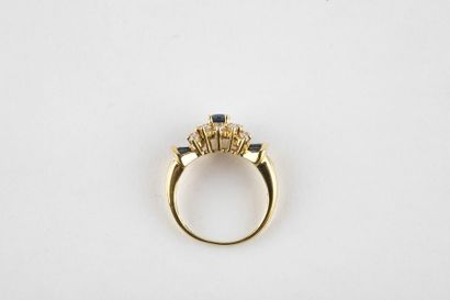 Yellow gold daisy ring holding an oval cut...