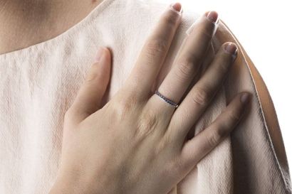 Half wedding ring in white gold set with...