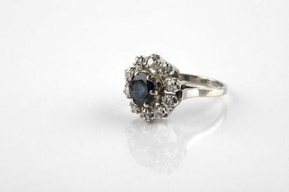 White gold ring adorned in the center with...