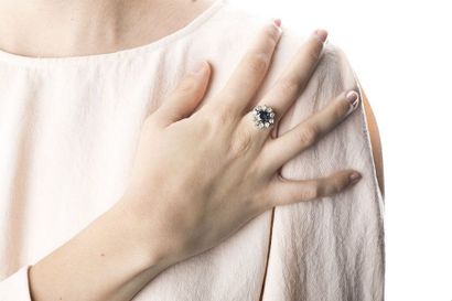 White gold ring adorned in the center with...