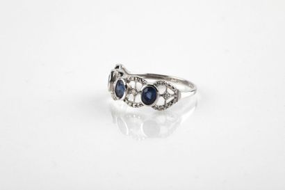 White gold ring set with three oval cut sapphires...