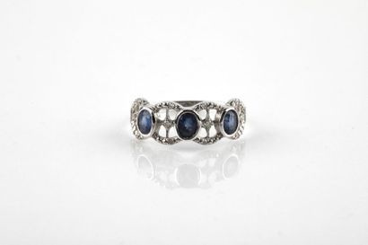 White gold ring set with three oval cut sapphires...