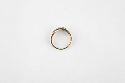 Yellow and white gold ring adorned with a...