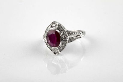 White gold ring adorned in the center with...