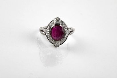 White gold ring adorned in the center with...