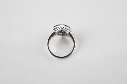 White gold ring adorned in the center with...