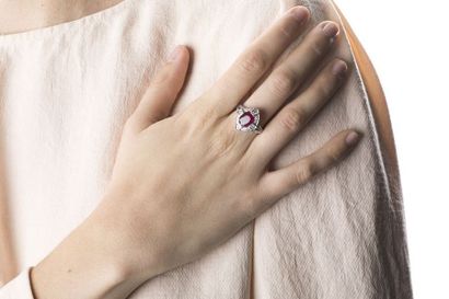 White gold ring adorned in the center with...