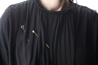 Set including two yellow gold pins, one representing...