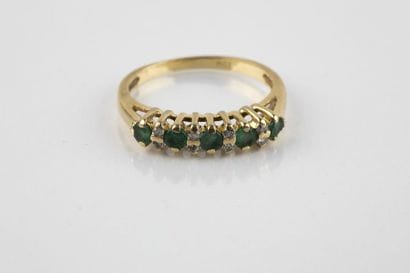 A yellow gold half wedding ring adorned with...