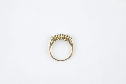 A yellow gold half wedding ring adorned with...