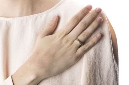 A yellow gold half wedding ring adorned with...