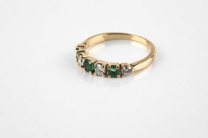 Half alliance in yellow gold with three round...