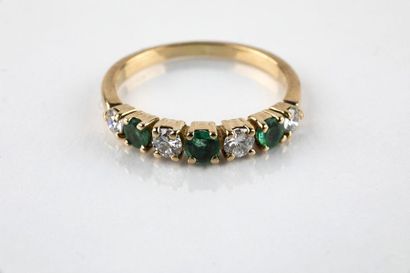 Half alliance in yellow gold with three round...
