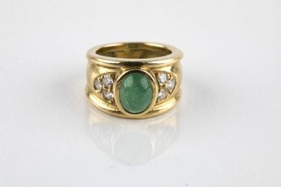 Yellow gold rush ring, adorned in the center...