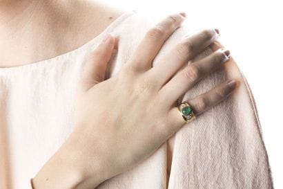 Yellow gold rush ring, adorned in the center...