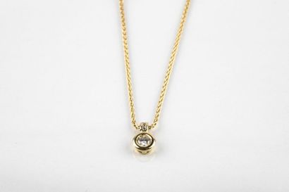 Yellow gold palm mesh necklace holding a...