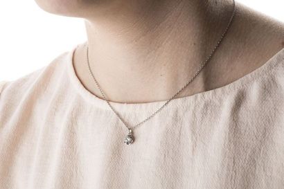 Round white gold chain with a pendant adorned...