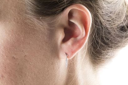 Pair of hanging earrings, in white gold holding...