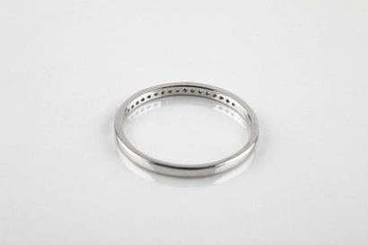 Half wedding ring in white gold set with...