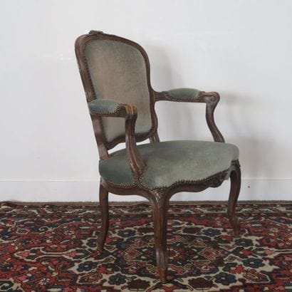 Moulded beech armchair carved with flowers,...