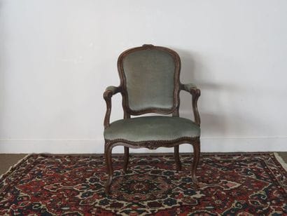 Moulded beech armchair carved with flowers,...