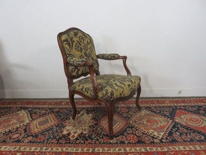 Armchair with flat back in moulded and carved...