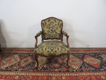 Armchair with flat back in moulded and carved...
