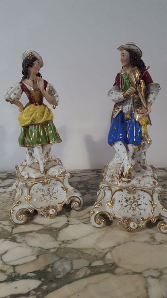 Two polychrome and gilded porcelain figurines...