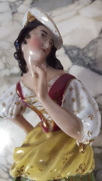 Two polychrome and gilded porcelain figurines...