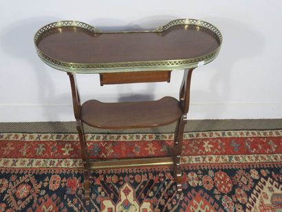 Mahogany kidney table opening to a small...
