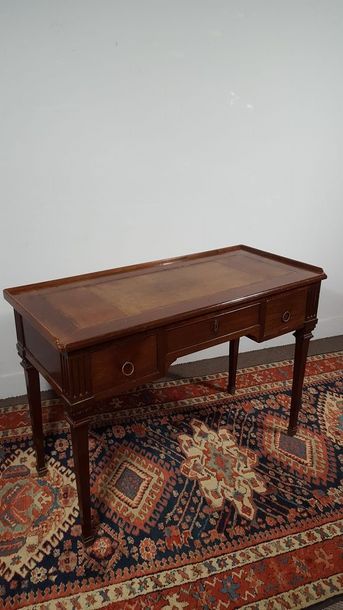 Small mahogany desk opening with three drawers...