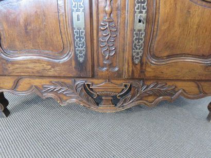 Moulded and carved walnut sideboard. Doors...