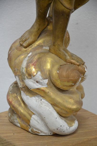 Carved and gilded wooden cherub. Standing...