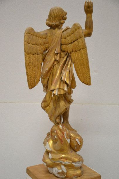 Carved and gilded wooden cherub. Standing...