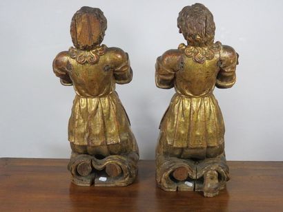 Pair of fir tree sculptures depicting kneeling...