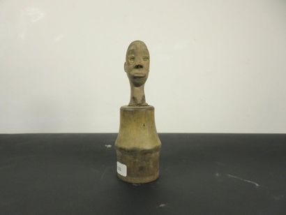 Wooden box with handle carved with a human...