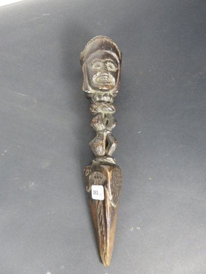 IMPORTANT PHURBU. Brown wood with a black...