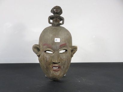 TWO MASKS Nigeria, one with a statuette on...