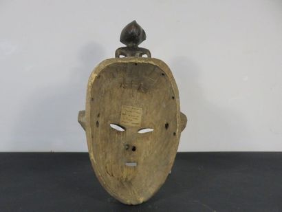 TWO MASKS Nigeria, one with a statuette on...