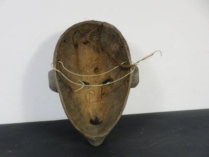 TWO MASKS Nigeria, one with a statuette on...