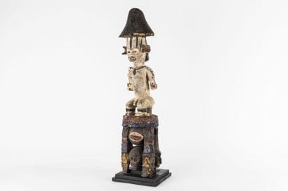 Male statue. The figure is depicted sitting...