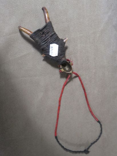 Necklace representing a character, the head...