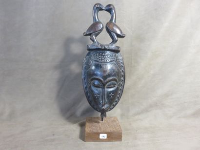 Facial mask representing an elongated human...