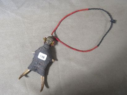 Necklace representing a character, the head...
