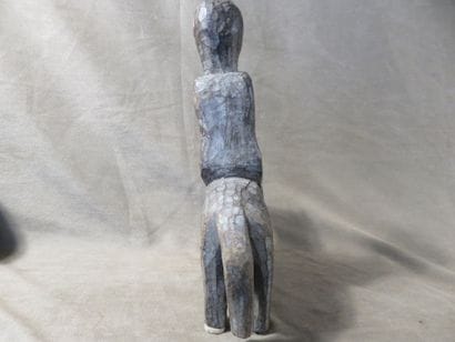 Statue of a man on horseback. Wood with grey...