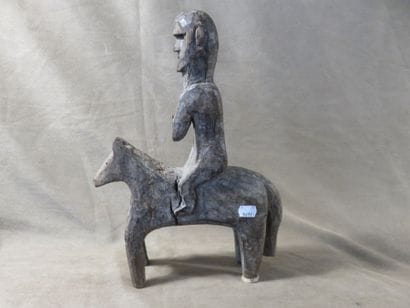 Statue of a man on horseback. Wood with grey...