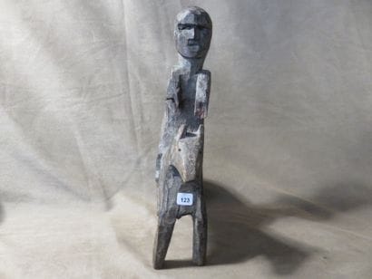 Statue of a man on horseback. Wood with grey...